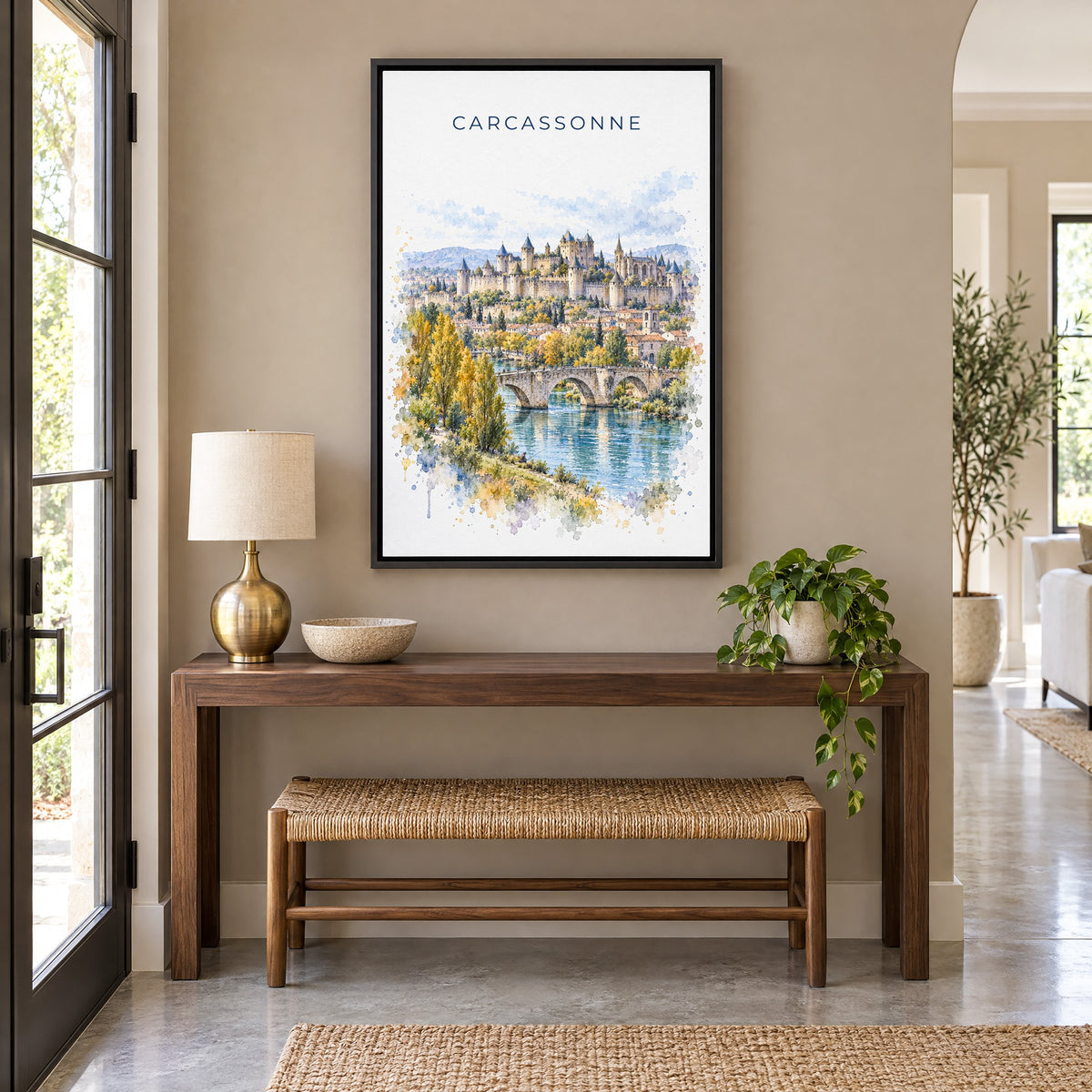 Carcassonne watercolor print as a black floater canvas above a walnut console and woven bench in an entryway