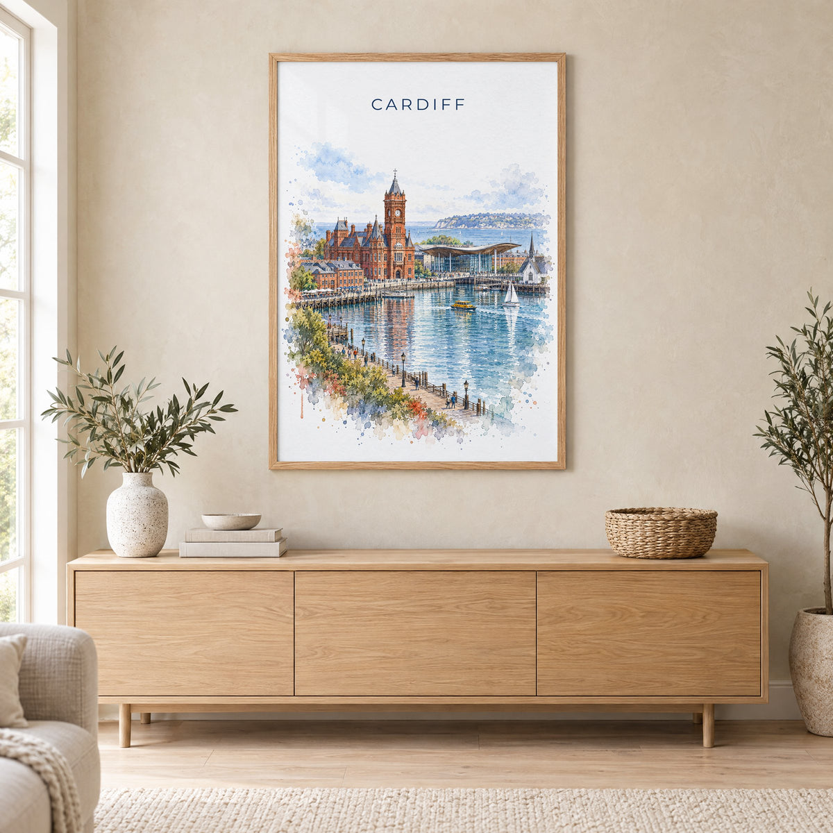 Cardiff watercolor print in an oak frame above a light wood sideboard in a Scandinavian living room