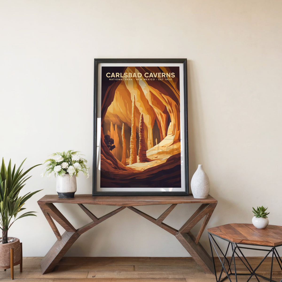 Carlsbad Caverns poster in a black frame on an entryway console table with white flowers