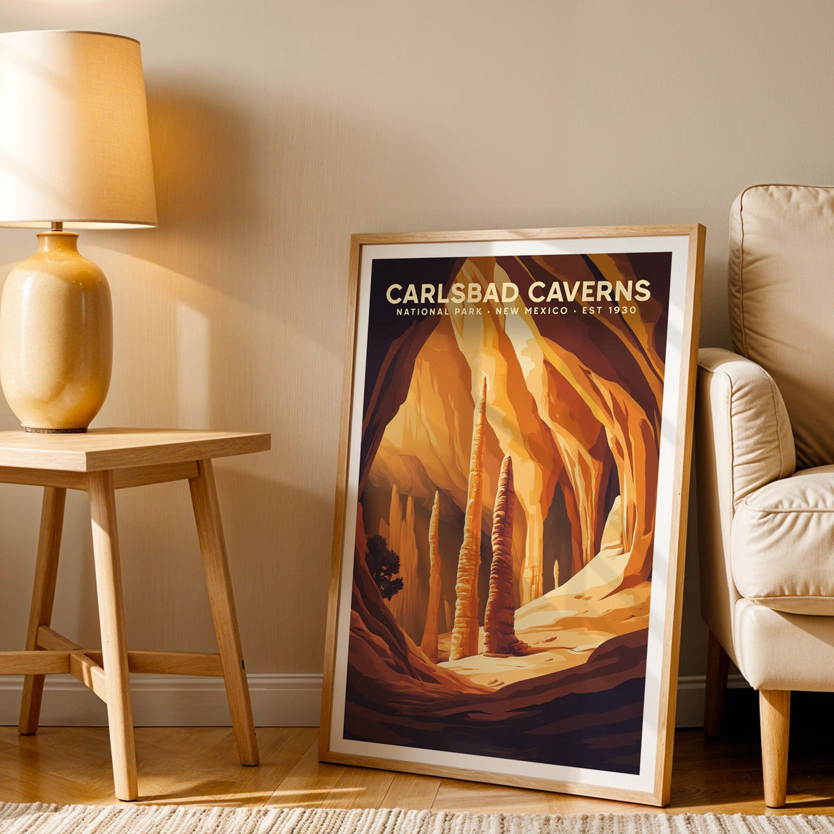 Carlsbad Caverns print in an oak frame beside a cream armchair and an amber lamp in warm light