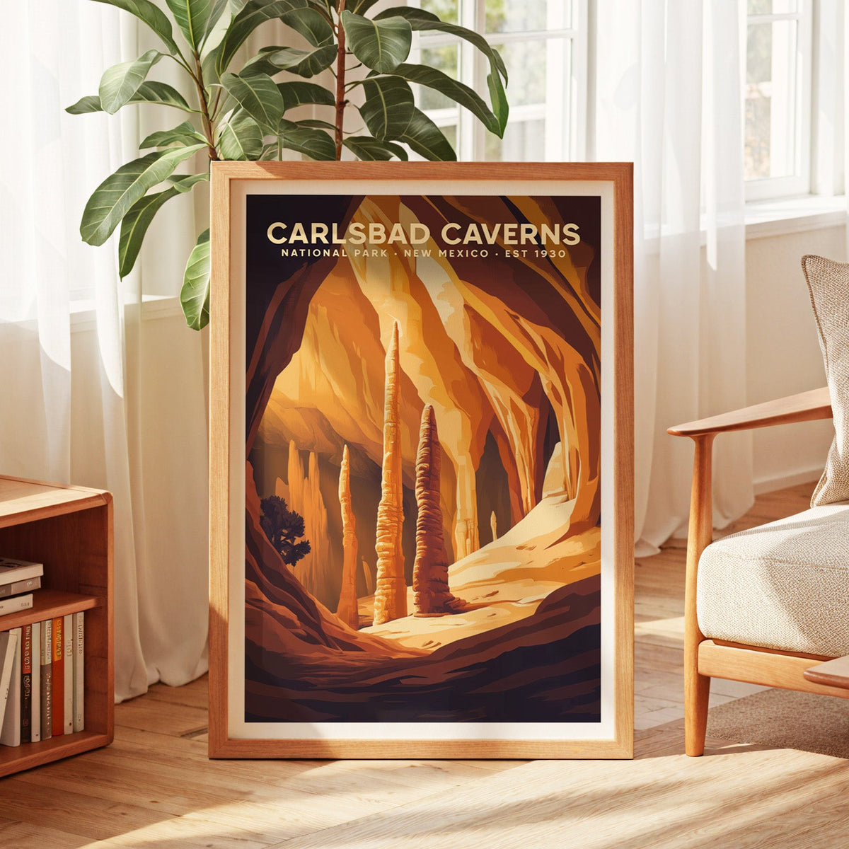 Carlsbad Caverns print in an oak frame by a sunlit window with sheer curtains and a fig plant
