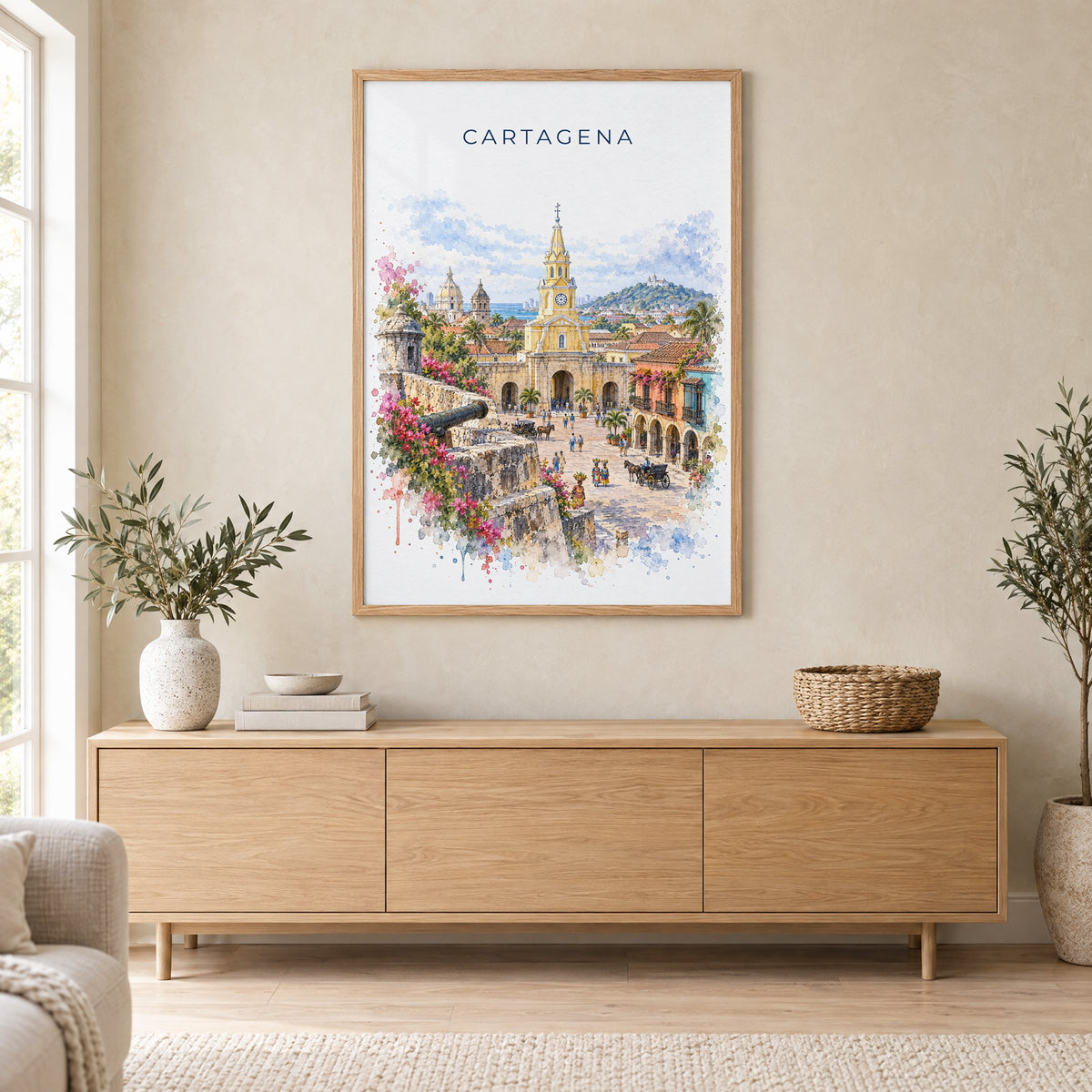 Cartagena, Colombia watercolor print in an oak frame above a light wood sideboard in a Scandinavian living room