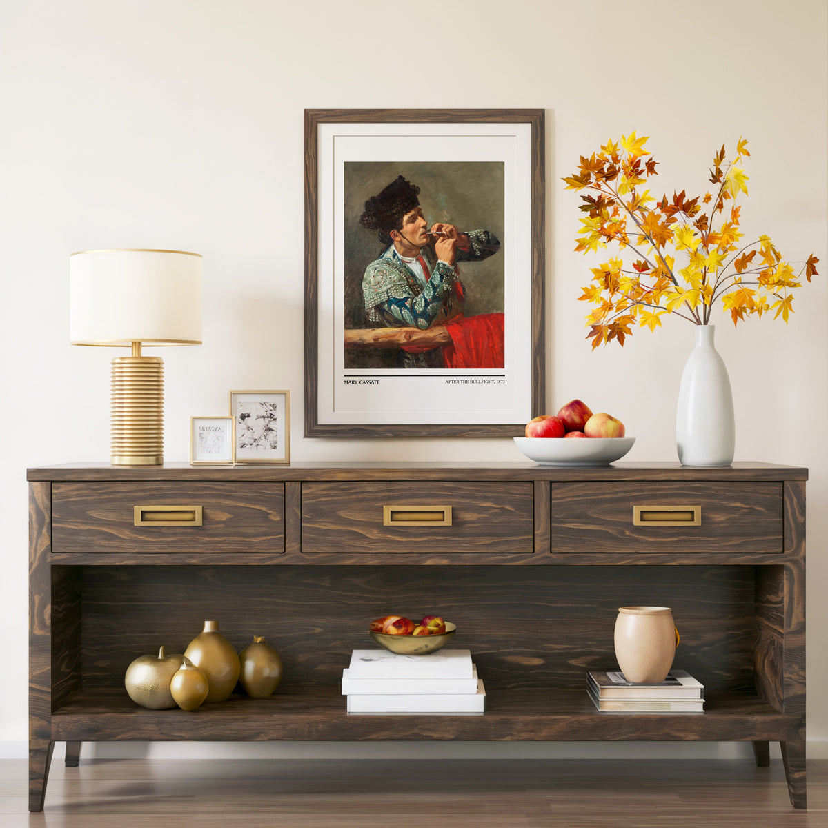 After the Bullfight print in a walnut frame above a console with autumn branches