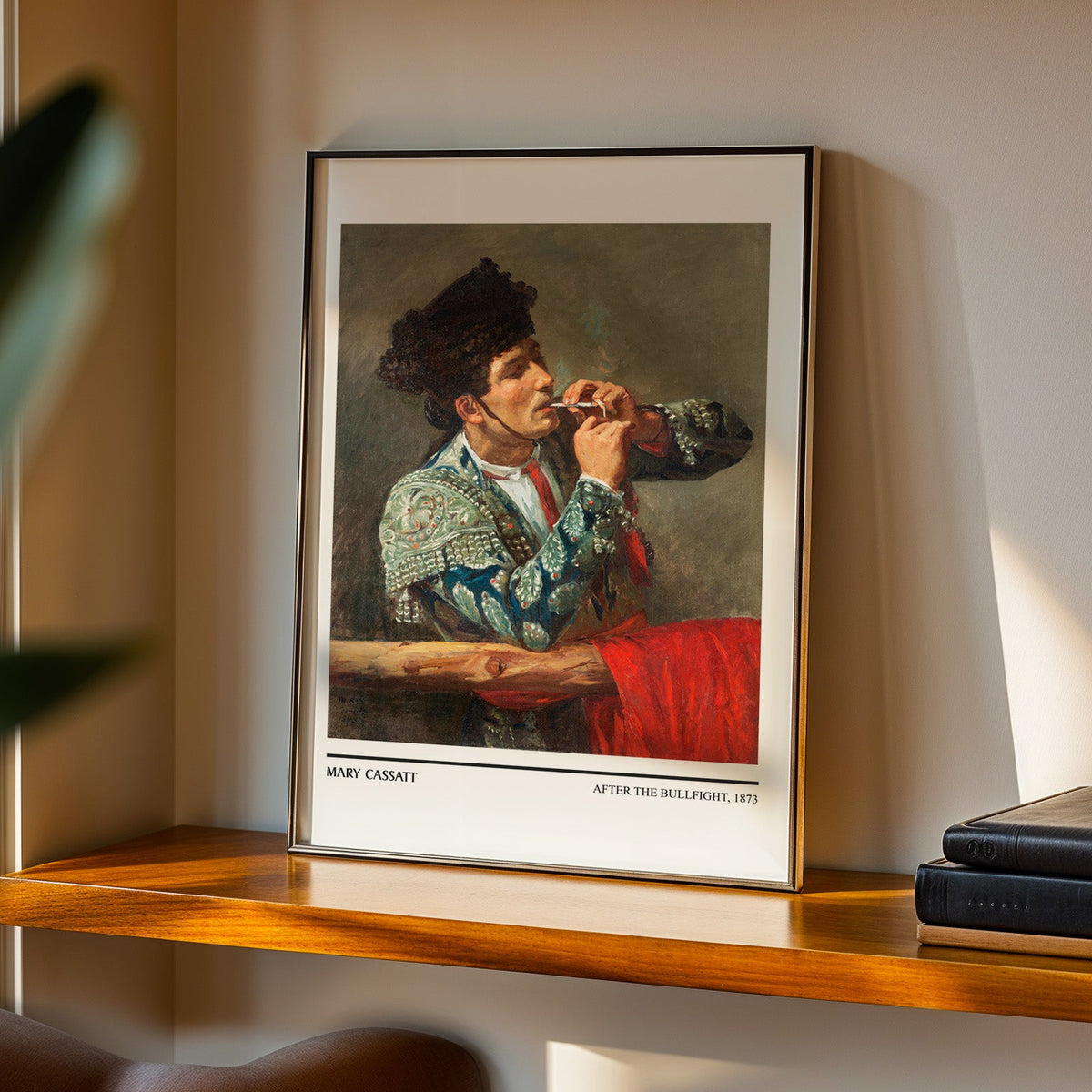 Mary Cassatt 1873 print in a black frame on a walnut shelf in evening light