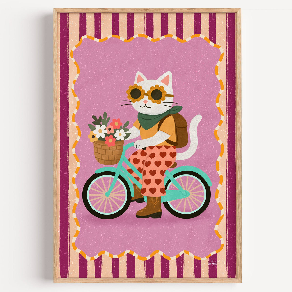 White cat riding a mint bicycle nursery print in a light oak frame on a plain white wall