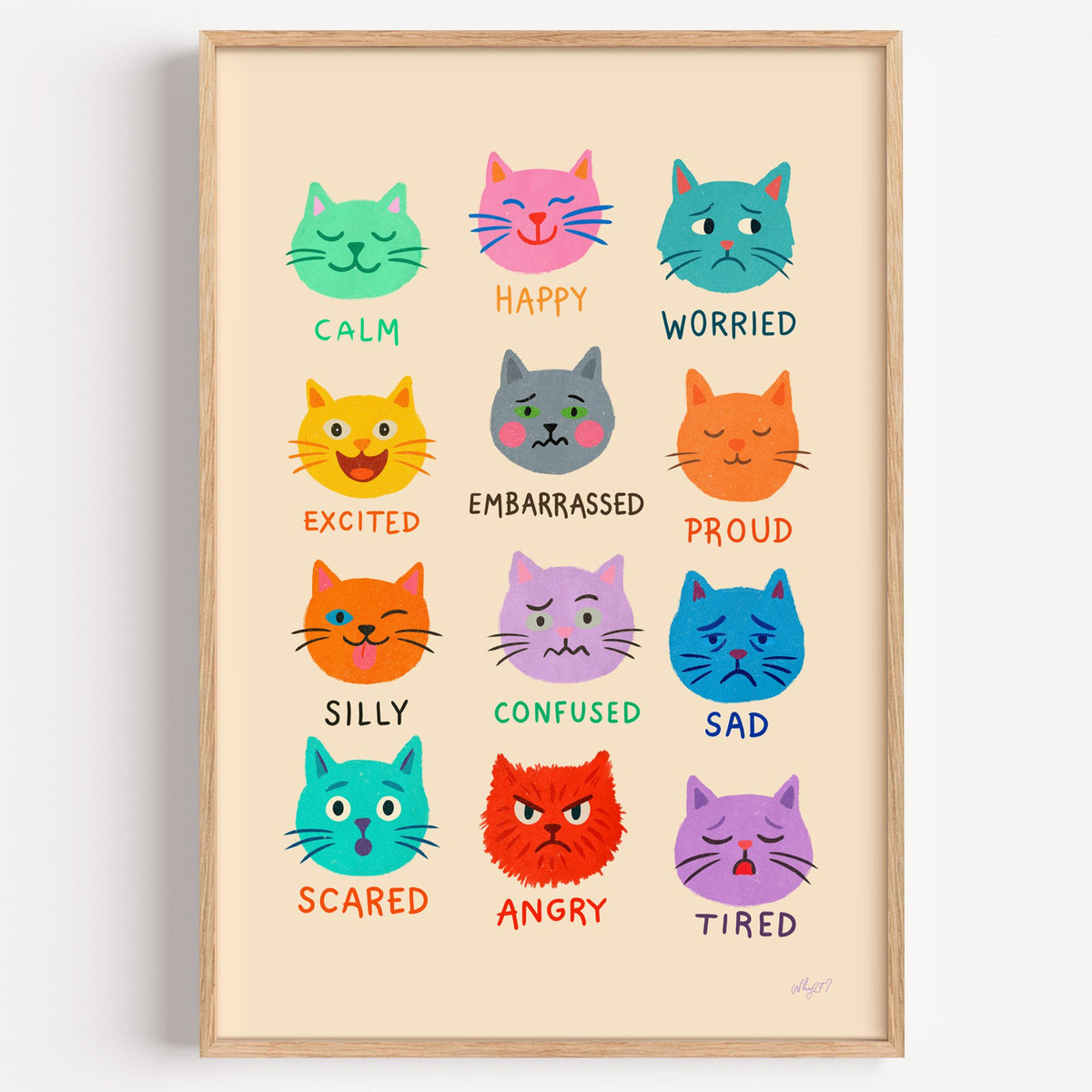Colourful cat feelings chart nursery print in a light oak frame on a plain white wall