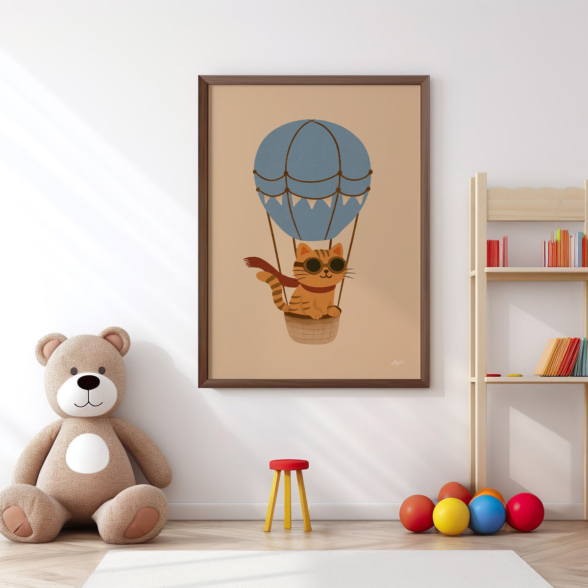 Cat in blue hot air balloon nursery print in a walnut frame above a big teddy bear by a bookshelf