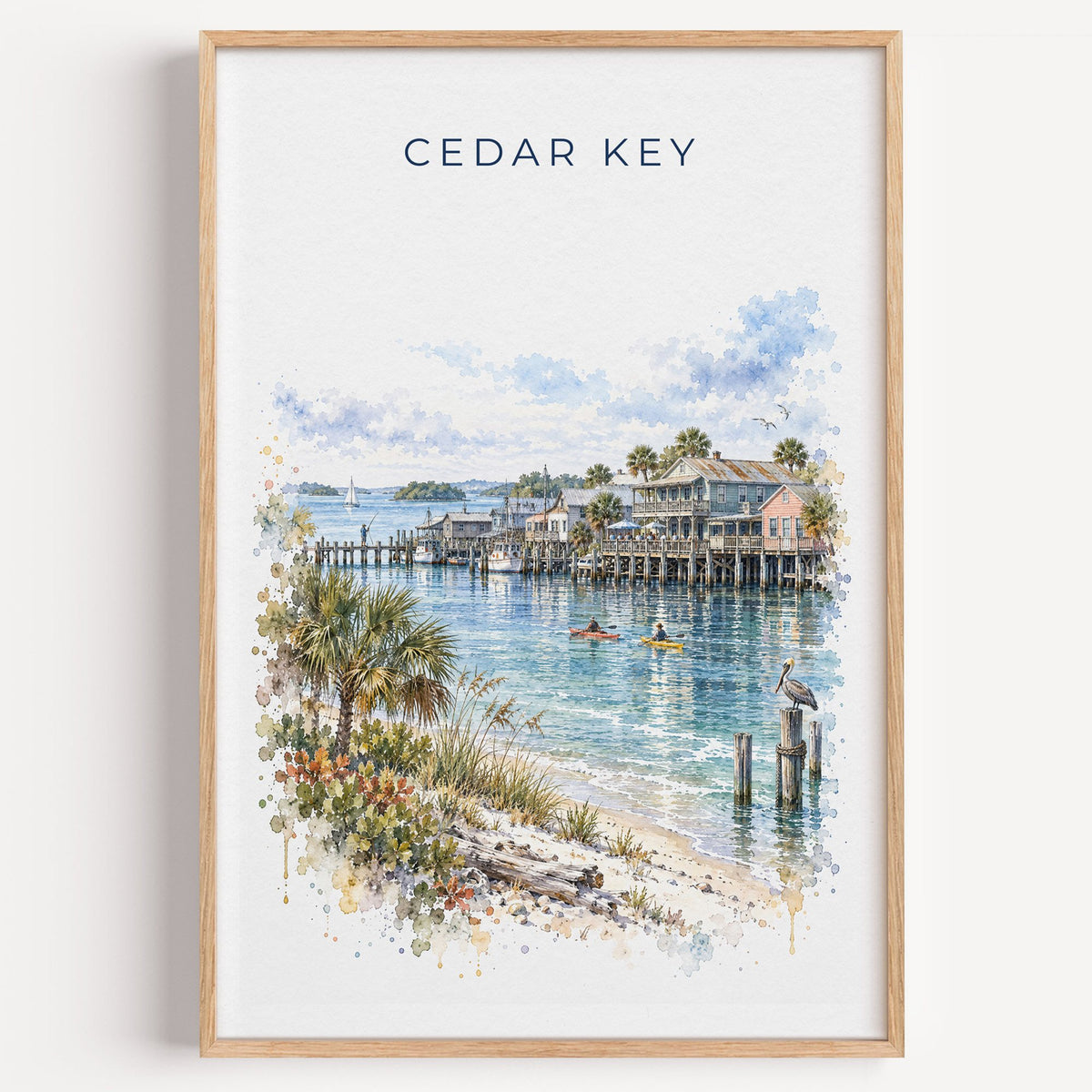 Cedar Key, Florida watercolor print in a light oak frame on a plain white wall
