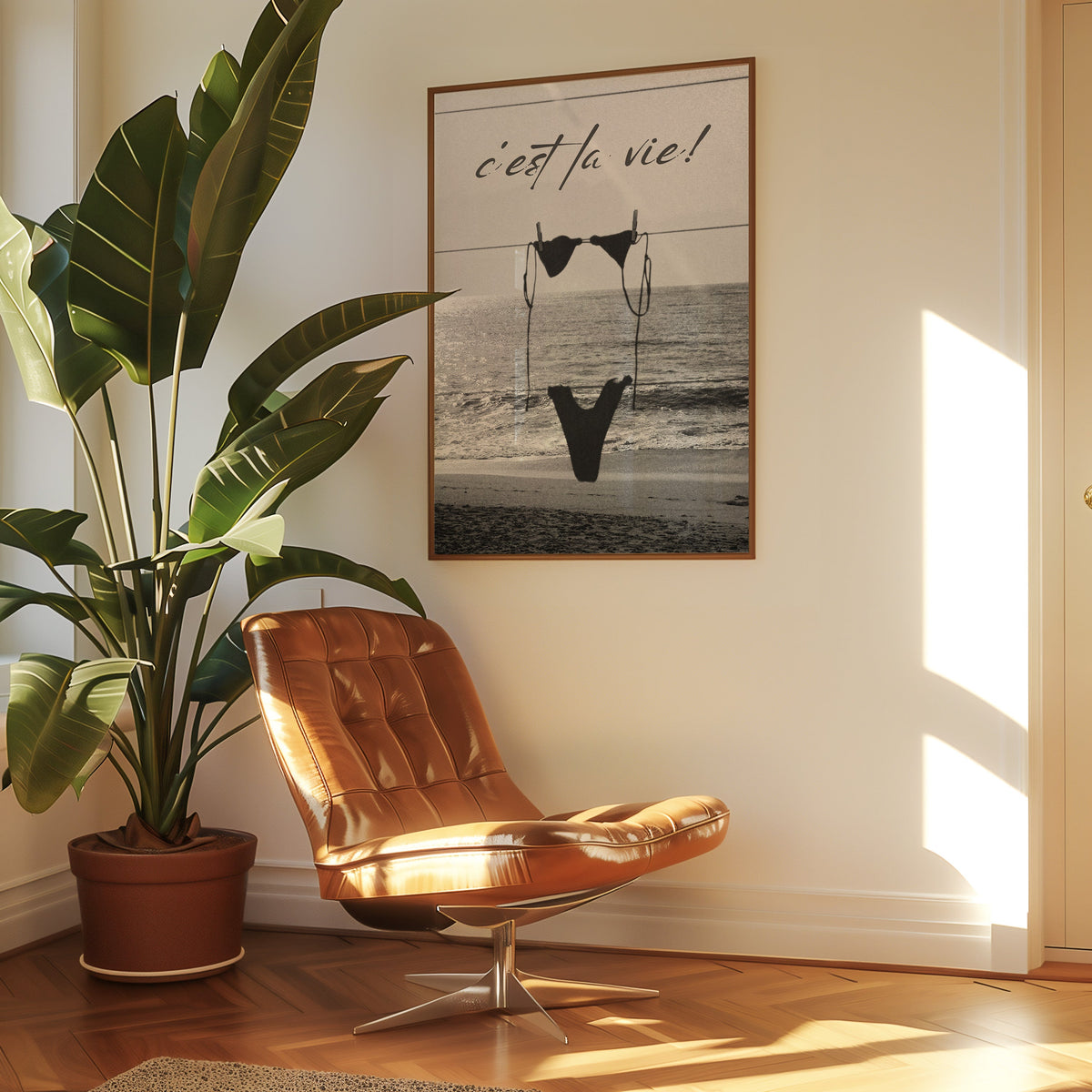 Black bikini on a clothesline over the sea print in a walnut frame above a leather lounge chair