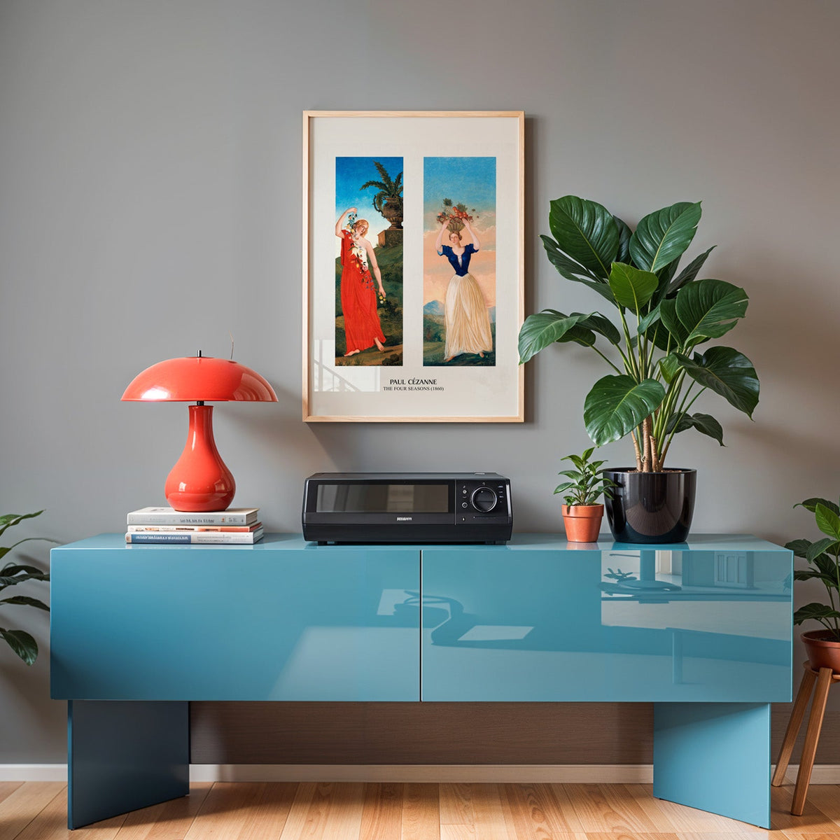 Cézanne print in an oak frame above a teal sideboard with a red lamp