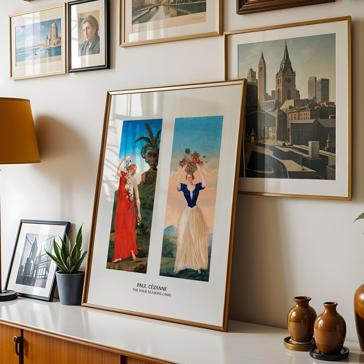Spring and Summer panels print shown in a gold frame leaning on a sideboard in a gallery wall