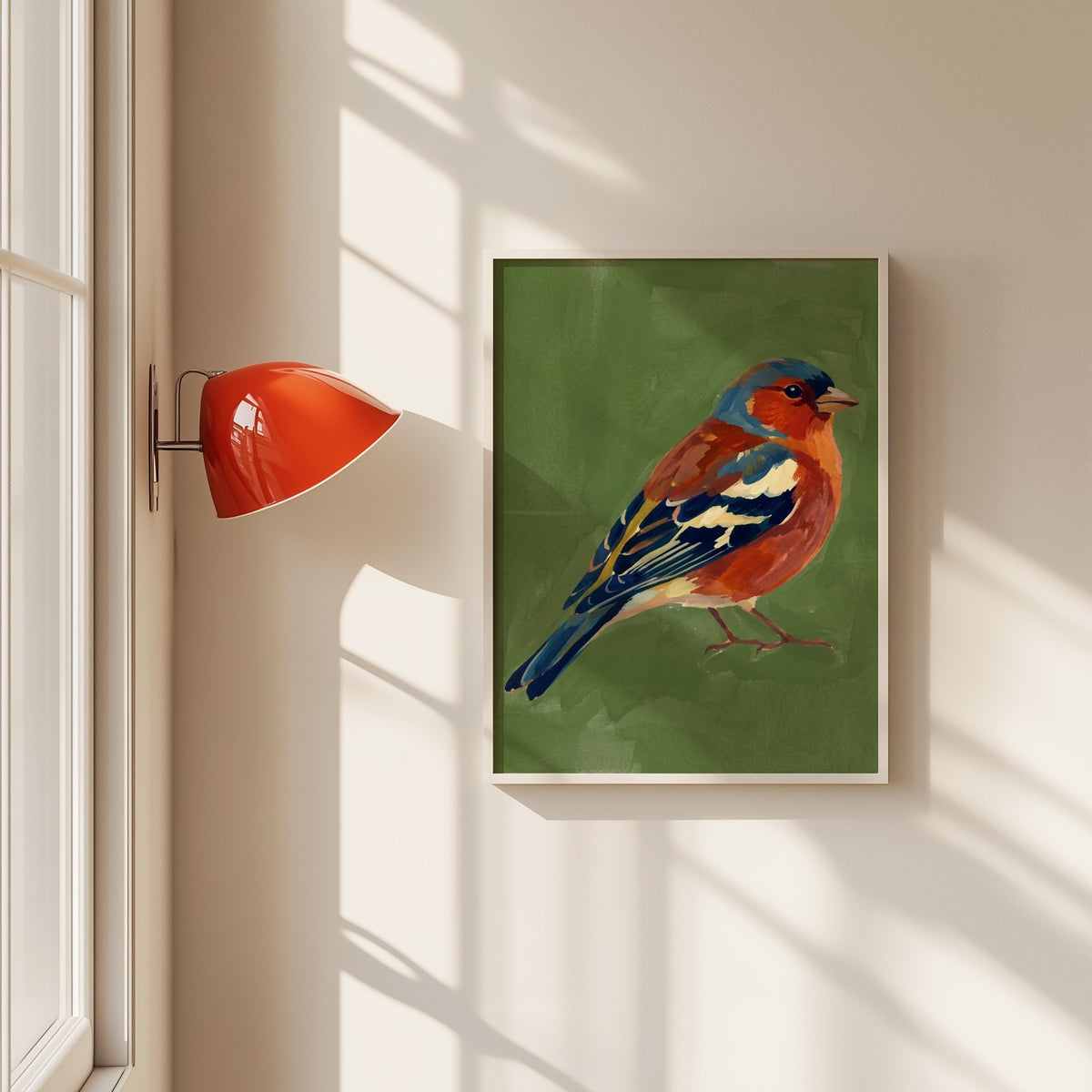 Chaffinch bird print in a white frame beside a red wall sconce