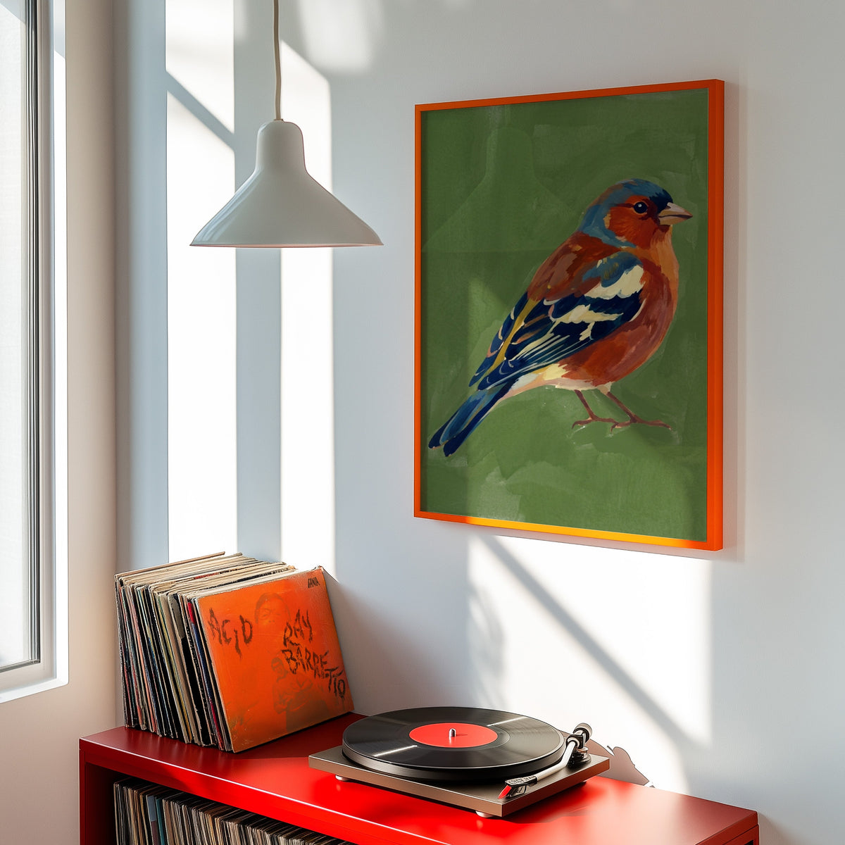 Moss green bird print shown in an orange frame above a red record cabinet and turntable