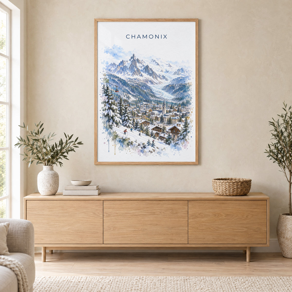 Chamonix watercolor print in an oak frame above a light wood sideboard in a Scandinavian living room