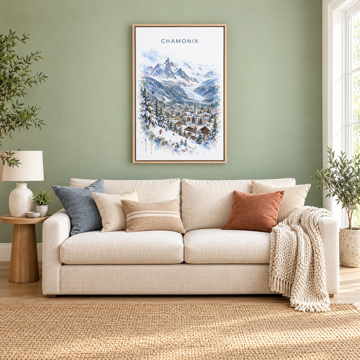Chamonix watercolor print as a natural floater canvas above a cream linen sofa on a sage green wall