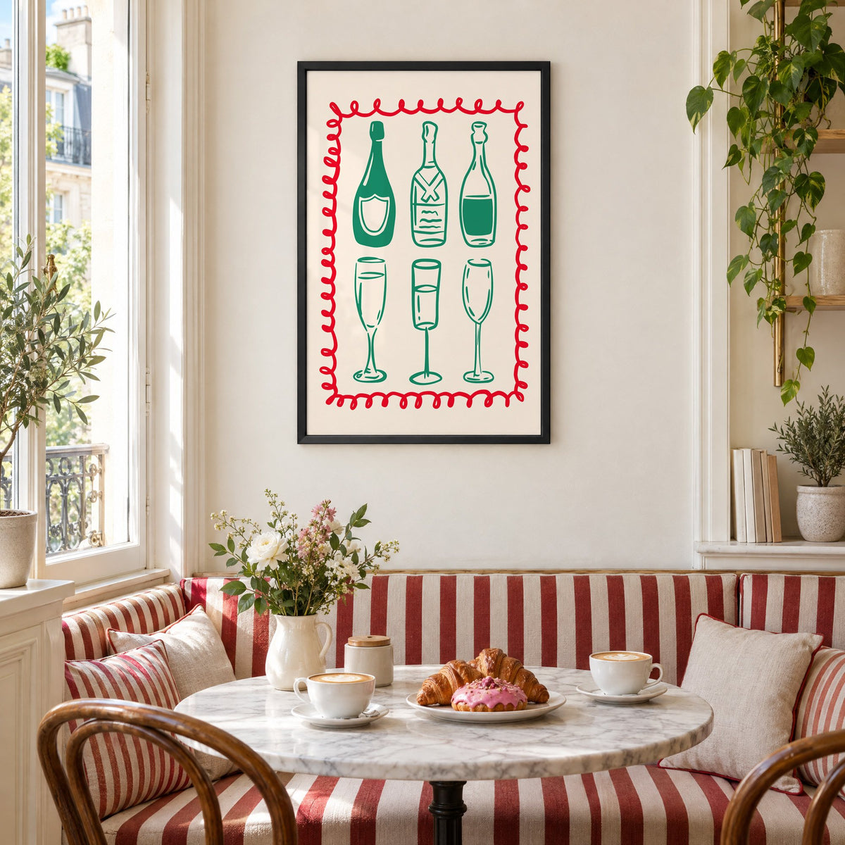 Green champagne bottles and glasses squiggle frame print in a black frame above a striped cafe breakfast nook with cappuccino and pastries