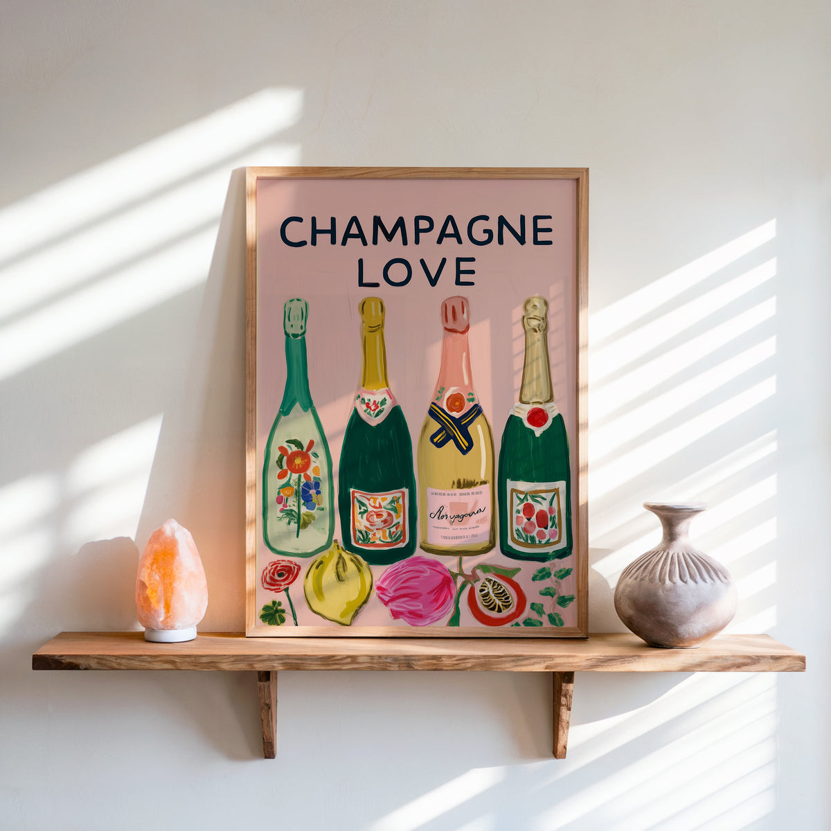 Champagne Love print in an oak frame on a live-edge shelf beside a salt lamp