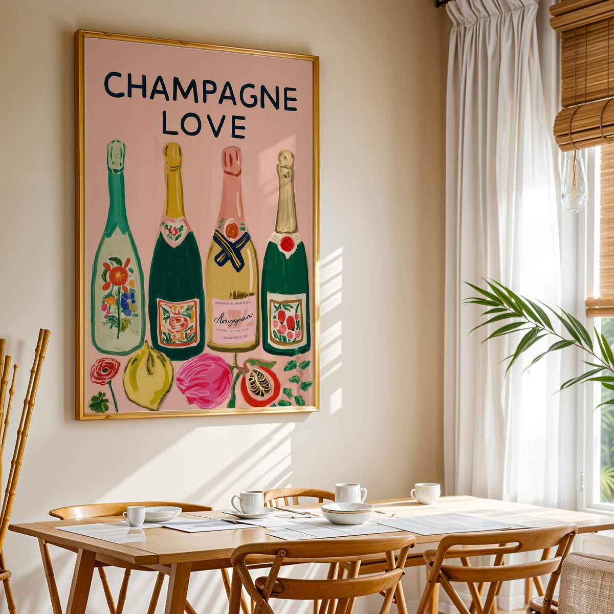 Champagne Love print shown in a gold frame above a breakfast table by a curtained window