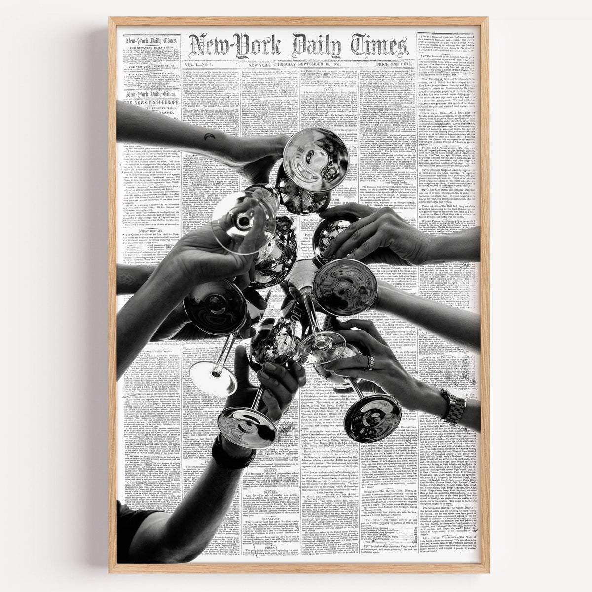 Champagne toast collage on 1851 newspaper print in a light oak frame on a plain white wall