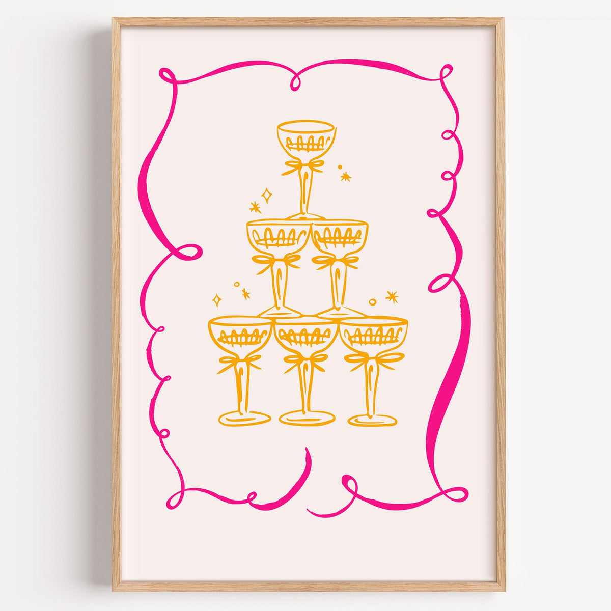 Champagne tower pink ribbon frame print in a light oak frame on a plain white wall