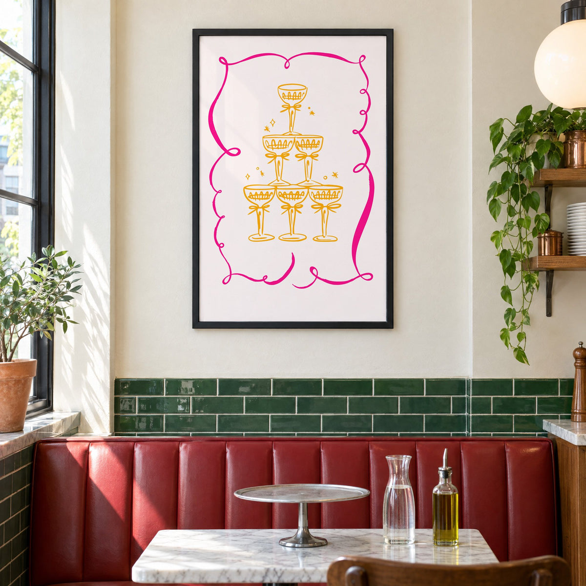 Champagne tower pink ribbon frame print in a black frame above a red leather booth in a sunny pizzeria