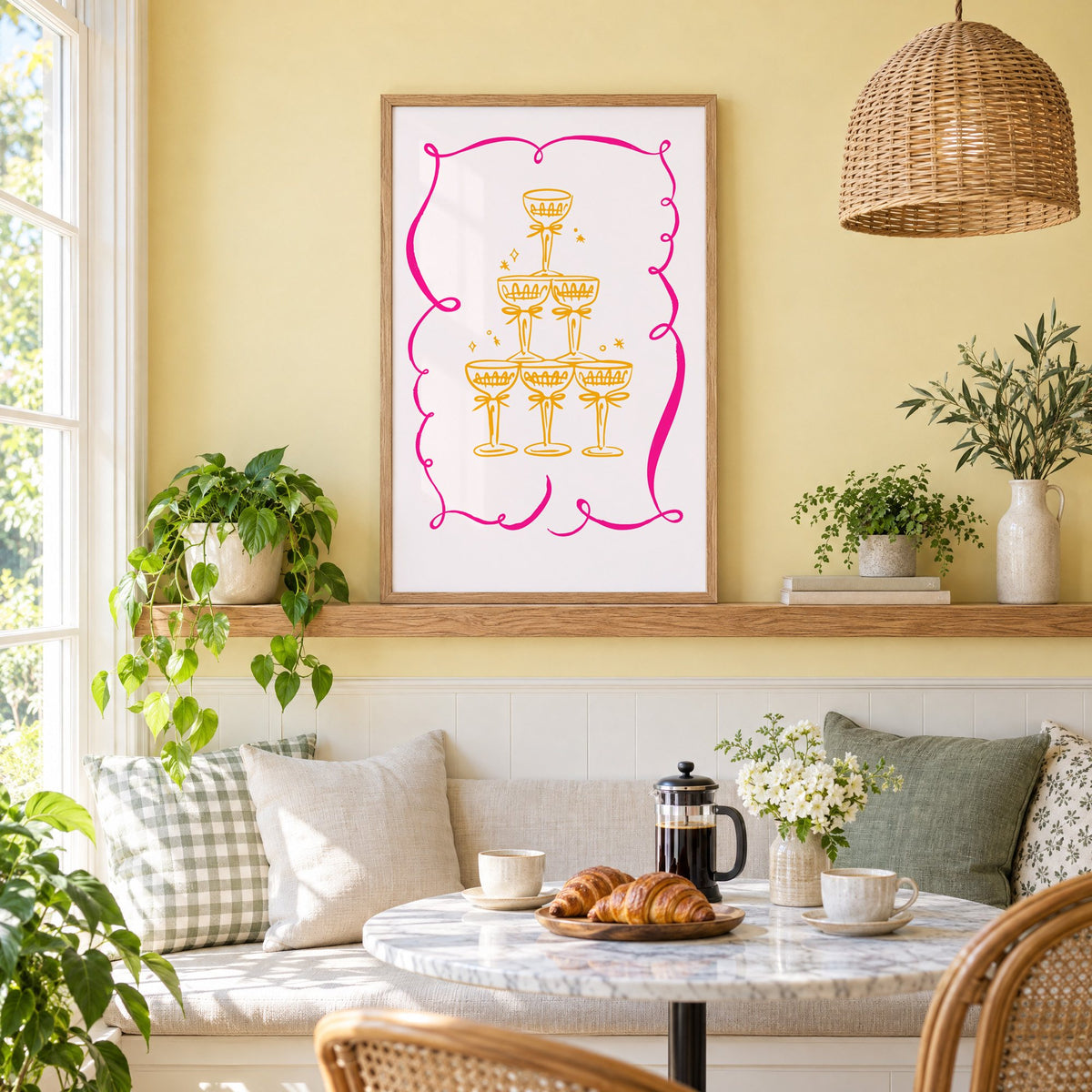 Champagne tower pink ribbon frame print in an oak frame on a picture ledge above a sunny breakfast nook