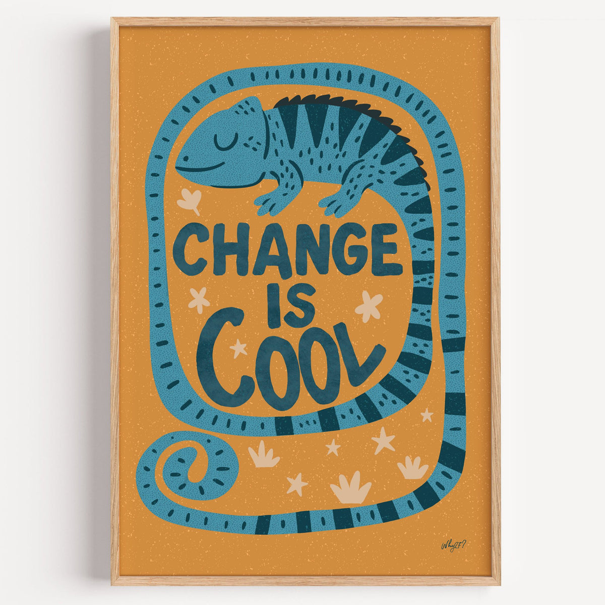 Change is cool chameleon orange nursery print in a light oak frame on a plain white wall