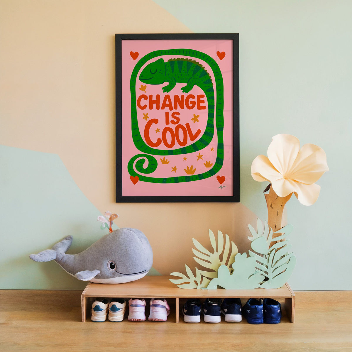 Change is cool chameleon pink nursery print in a black frame on a mint and peach wall above a whale plush