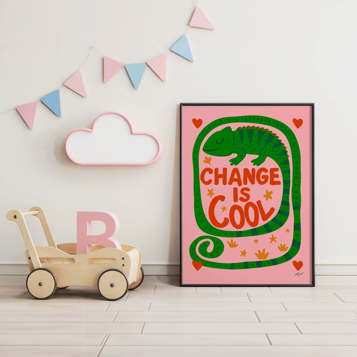 Change is cool chameleon pink nursery print in a black frame under pastel bunting by a wooden baby walker