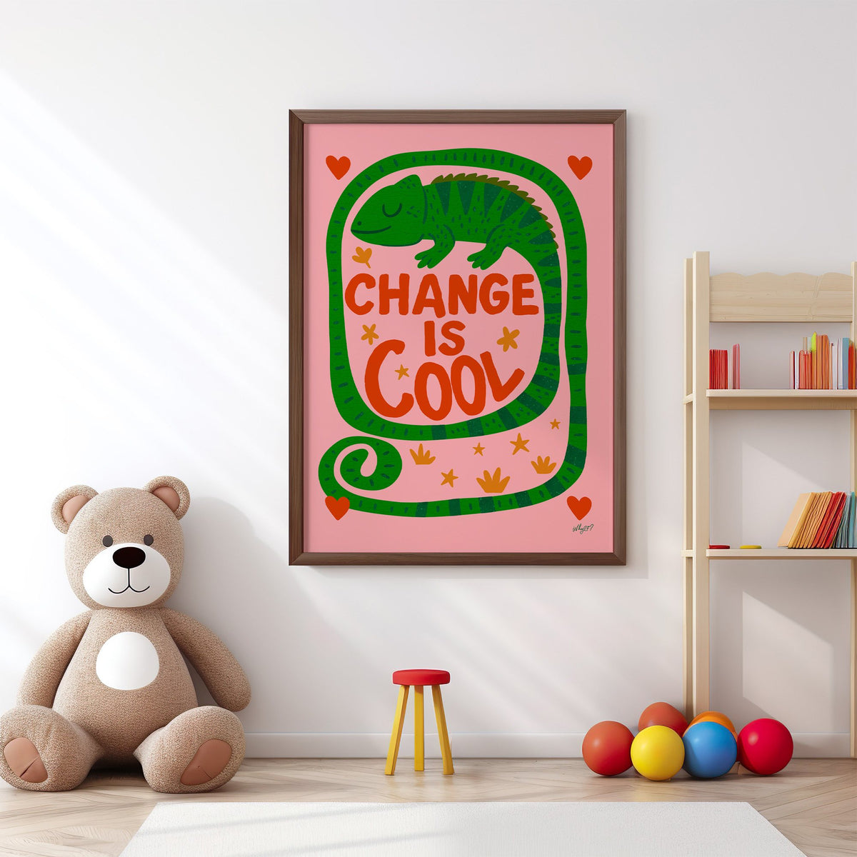 Change is cool chameleon pink nursery print in a walnut frame above a big teddy bear by a bookshelf