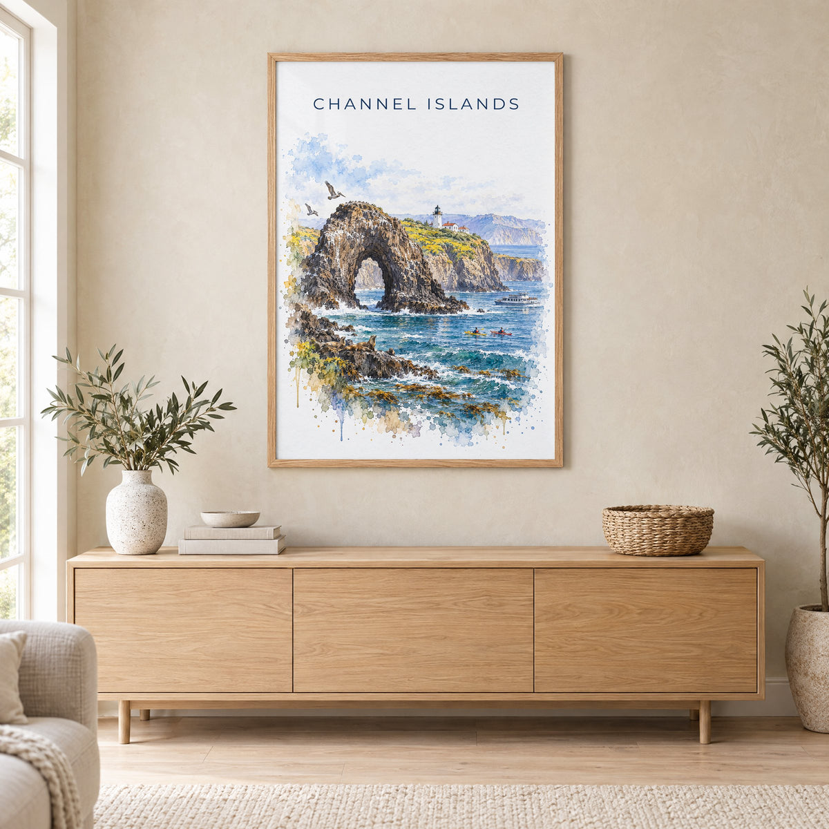 Channel Islands National Park watercolor print in an oak frame above a light wood sideboard in a Scandinavian living room
