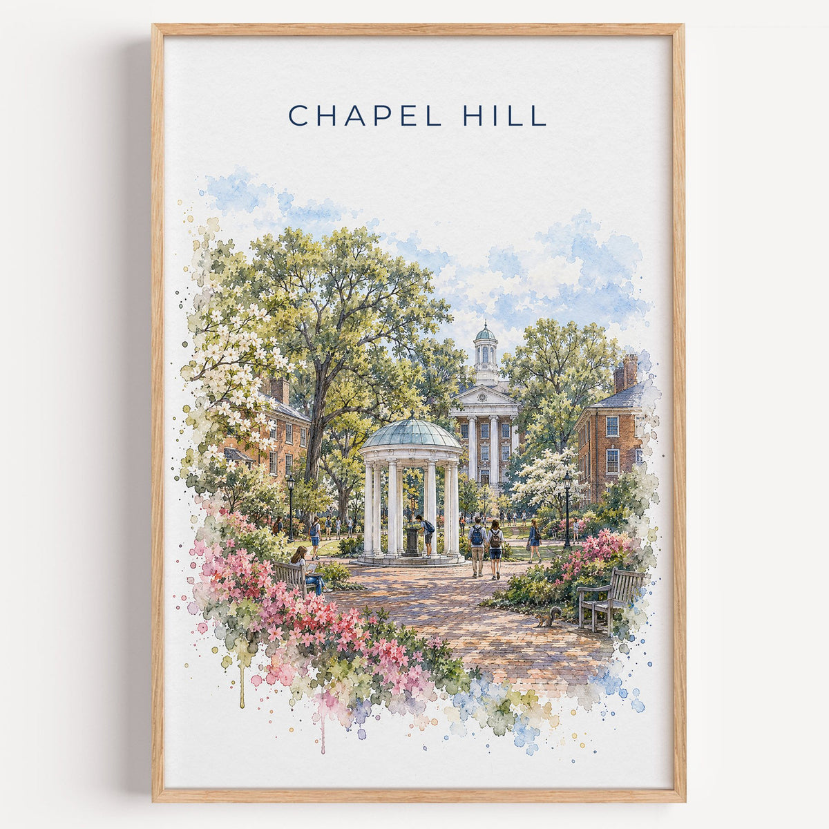 Chapel Hill watercolor print in a light oak frame on a plain white wall