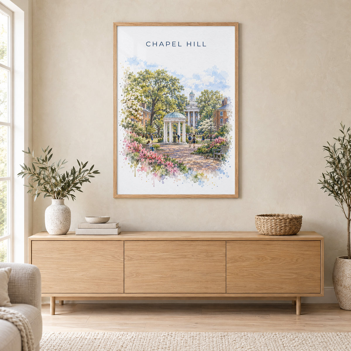 Chapel Hill watercolor print in an oak frame above a light wood sideboard in a Scandinavian living room