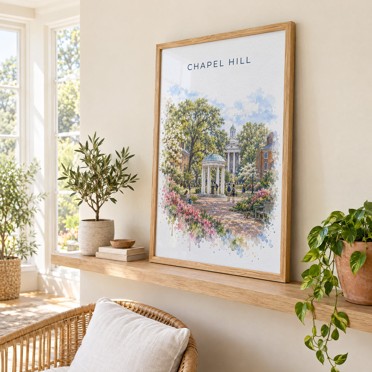 Chapel Hill watercolor print in an oak frame on a picture ledge in a sunlit sunroom