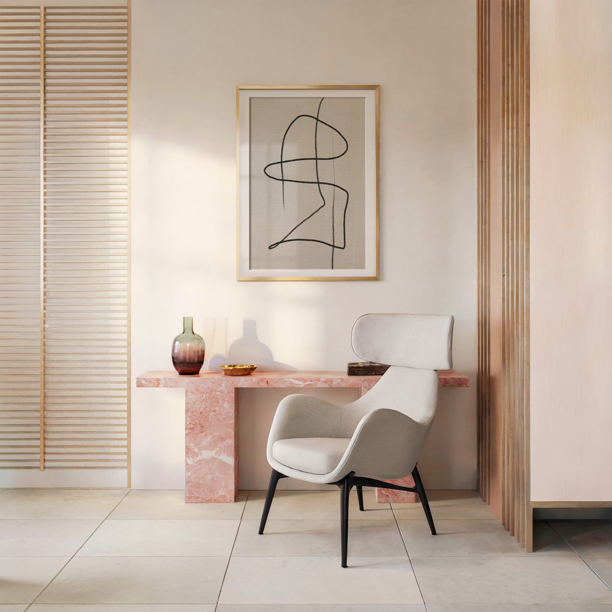 Charcoal continuous loop line art print shown in a gold frame with a mat above a pink marble console and armchair