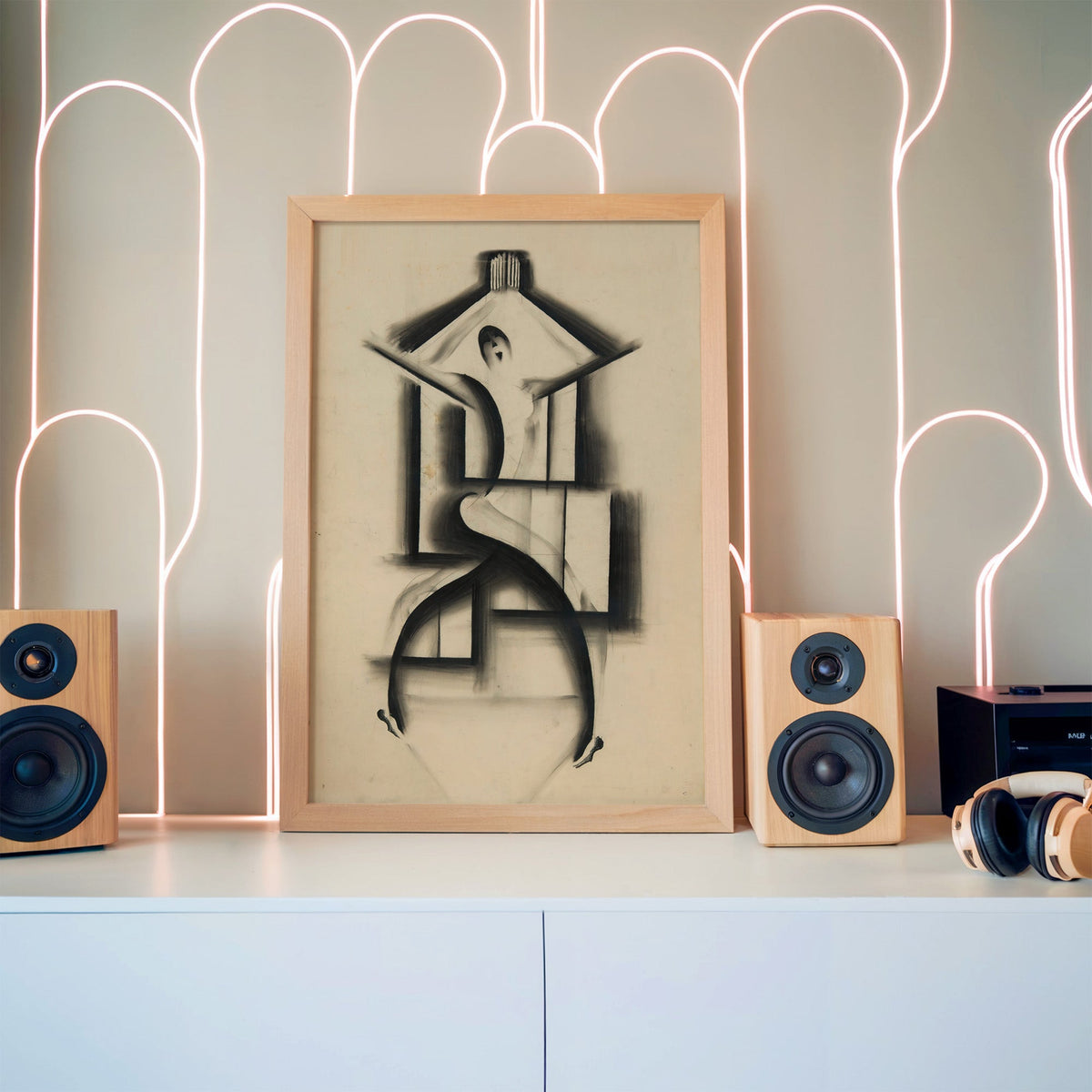 Charcoal dancer in house frame sketch print in a pine frame between wooden speakers by a neon arch light wall