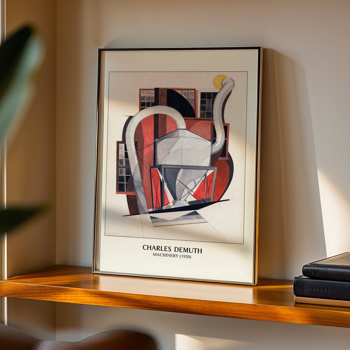 Machinery print in a black frame on a walnut shelf in warm evening light