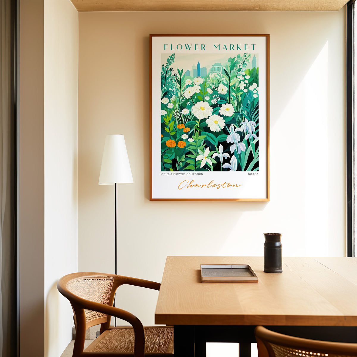 Charleston flower market print in an oak frame above a dining table and cane chair