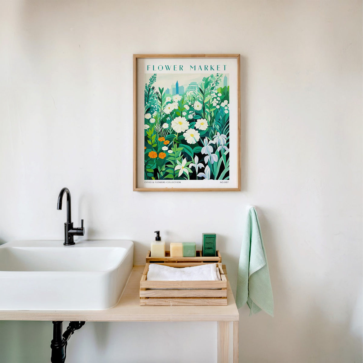 Charleston flower market print in an oak frame above a white bathroom sink with folded towels