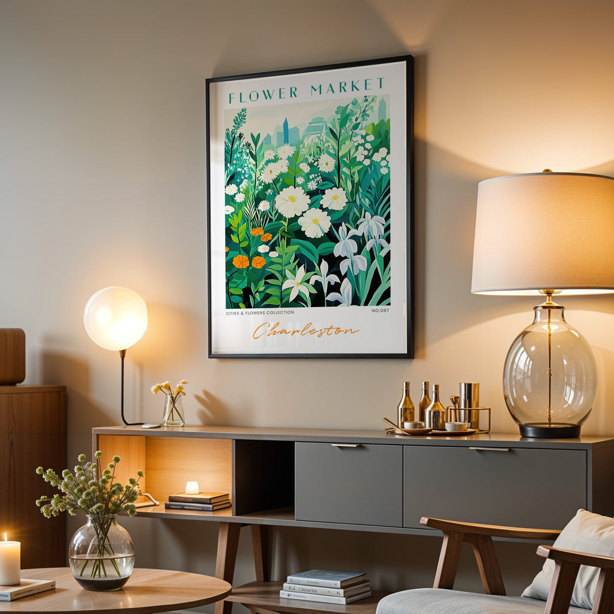 Charleston flower market print in a black frame above a grey media console with a glass table lamp