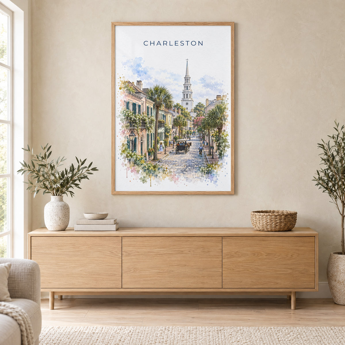 Charleston watercolor print in an oak frame above a light wood sideboard in a Scandinavian living room