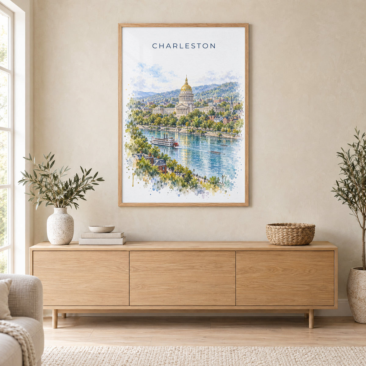 Charleston, West Virginia watercolor print in an oak frame above a light wood sideboard in a Scandinavian living room