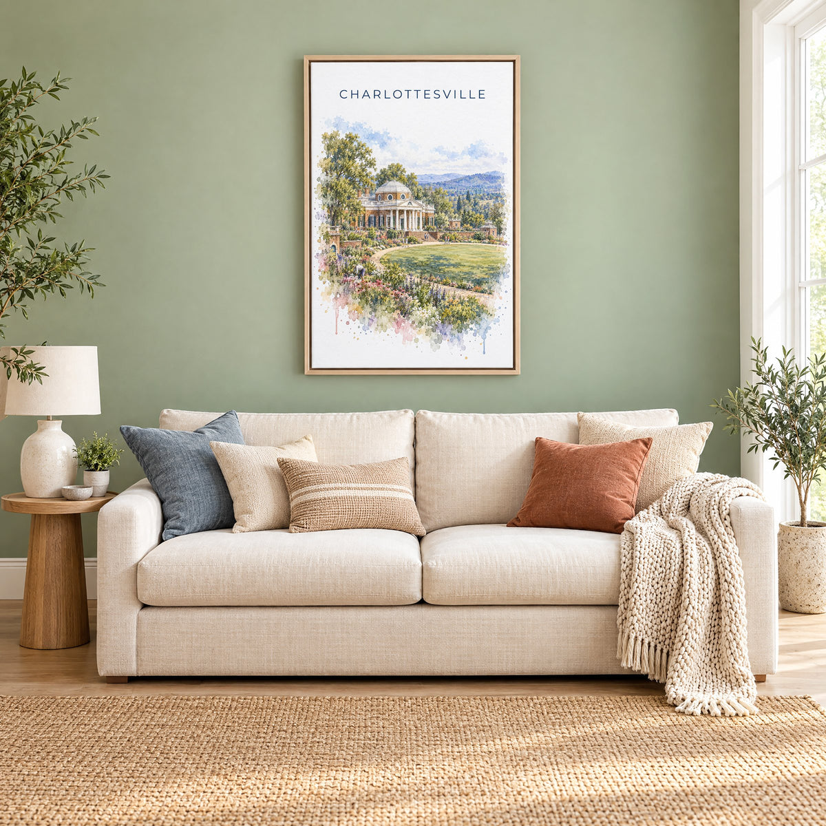 Charlottesville watercolor print as a natural floater canvas above a cream linen sofa on a sage green wall
