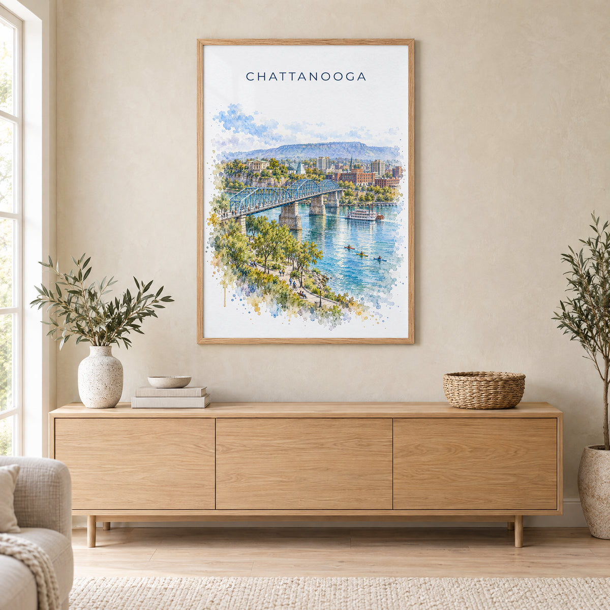 Chattanooga watercolor print in an oak frame above a light wood sideboard in a Scandinavian living room