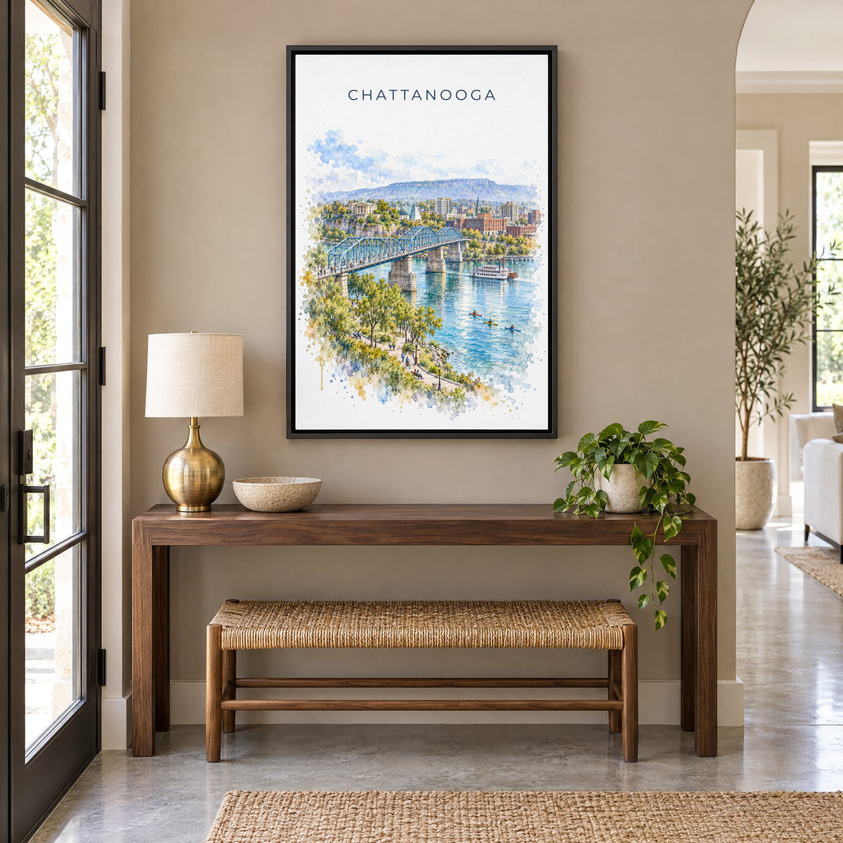 Chattanooga watercolor print as a black floater canvas above a walnut console and woven bench in an entryway