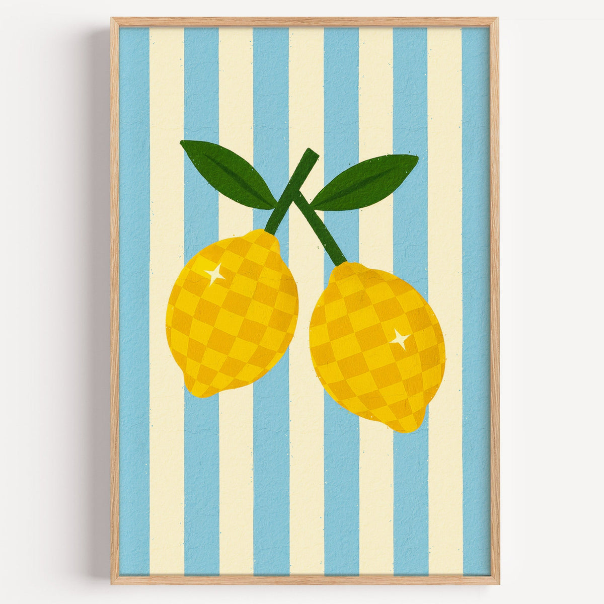 Checkered lemons print in a light oak frame on a plain white wall