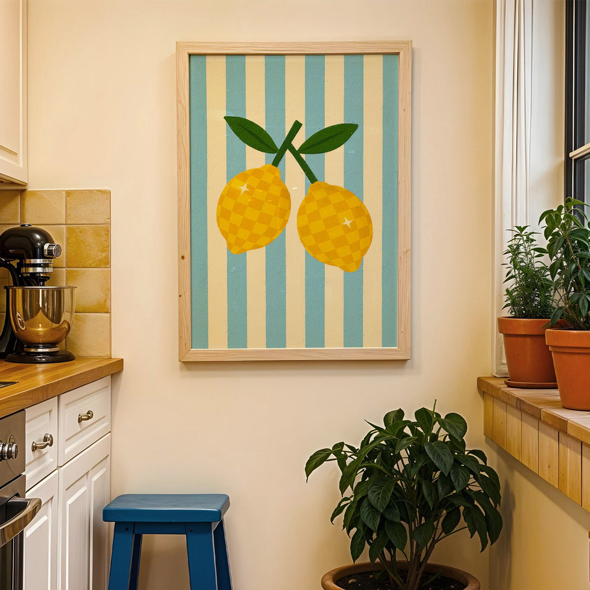 Checkered lemons print in a wood frame on a yellow tiled kitchen wall