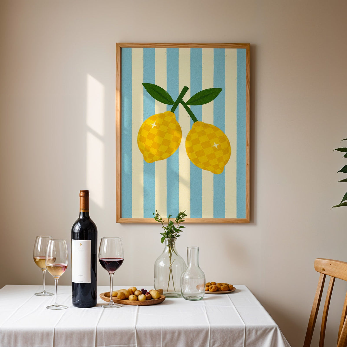 Checkered lemons print in an oak frame above a table laid with wine and glasses