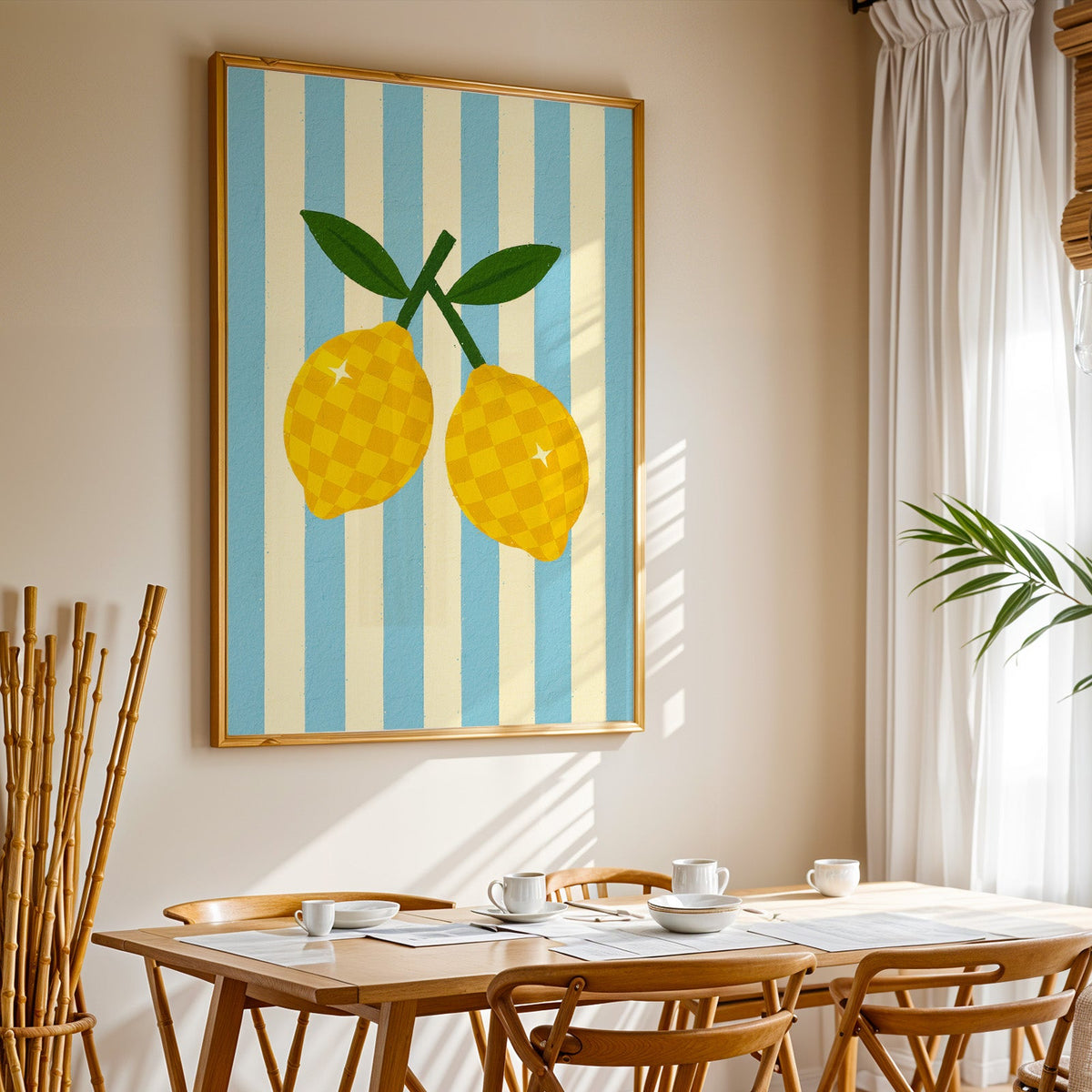 Checkered lemons print in a gold frame above a sunlit breakfast table