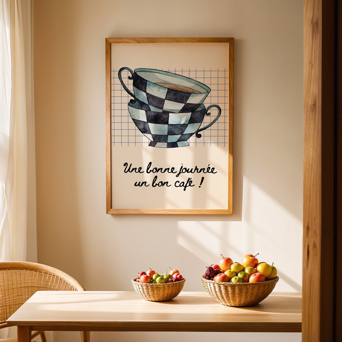 Checkered teacups French coffee print in an oak frame above a light wood dining table with baskets of fruit